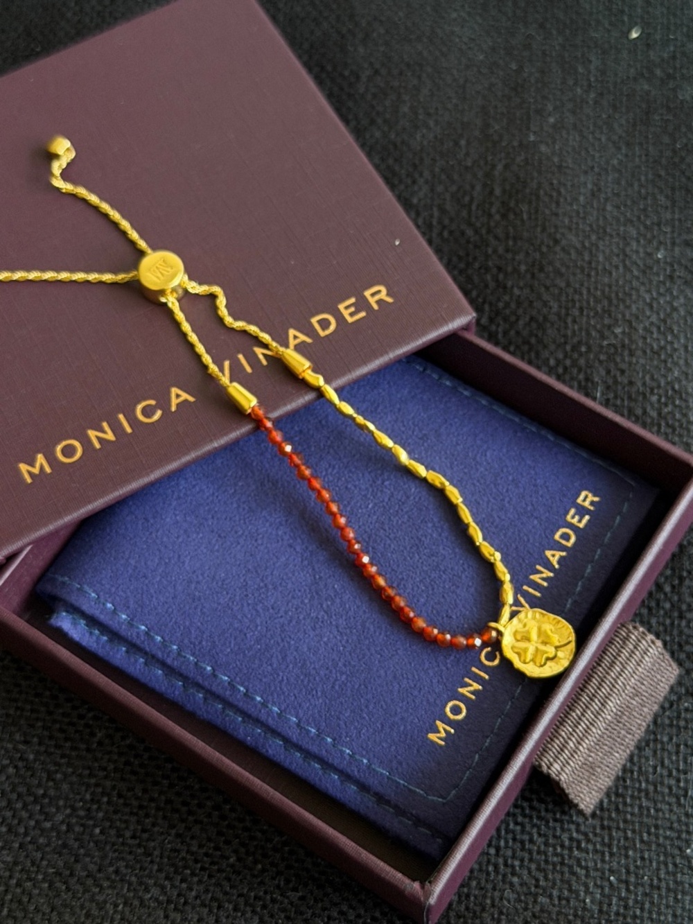 Monica Vinader Red Gemstone Gold Bracelet with clover pendant